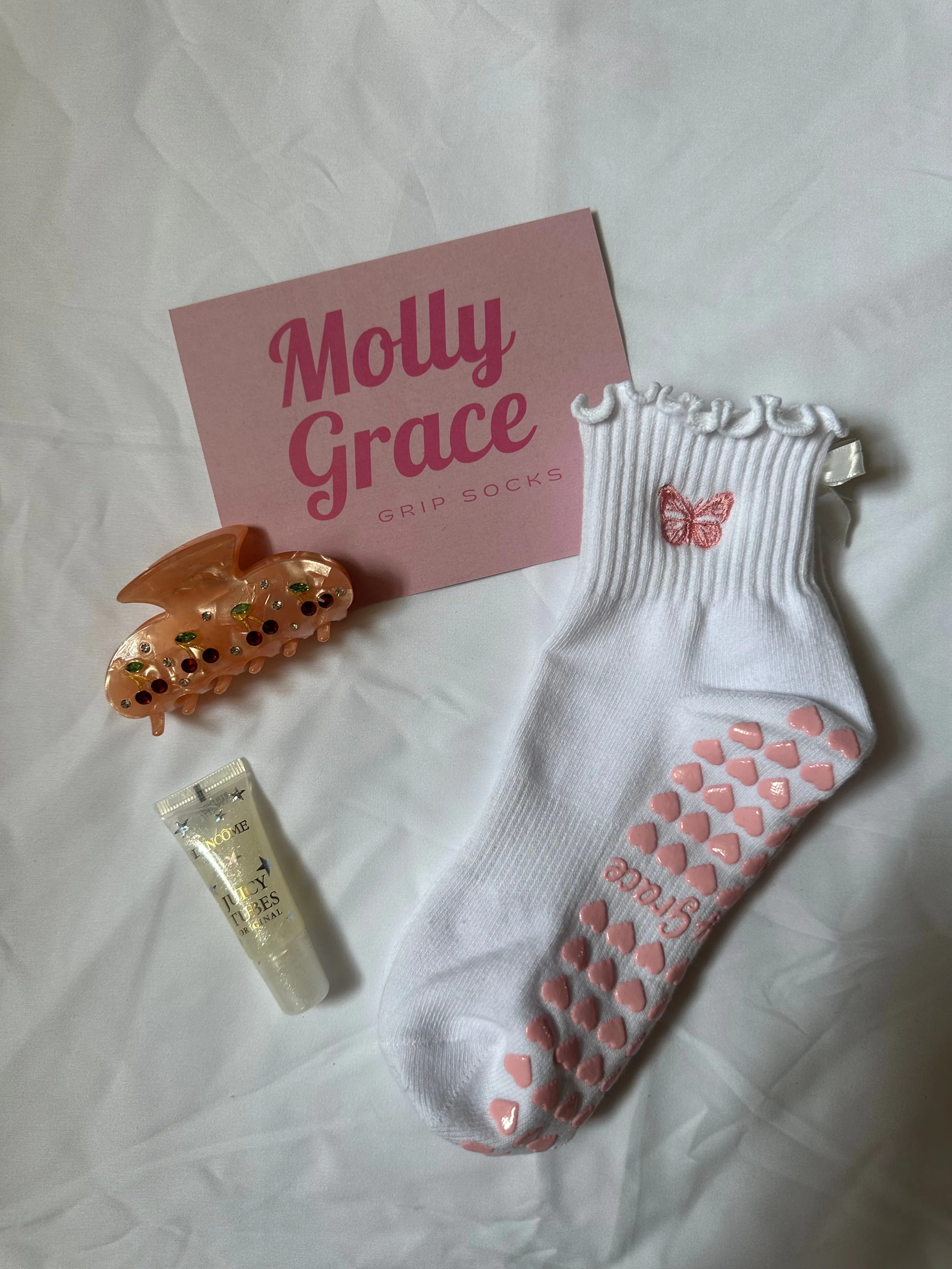 White ruffle grip sock with white bow and pink embroidered butterfly